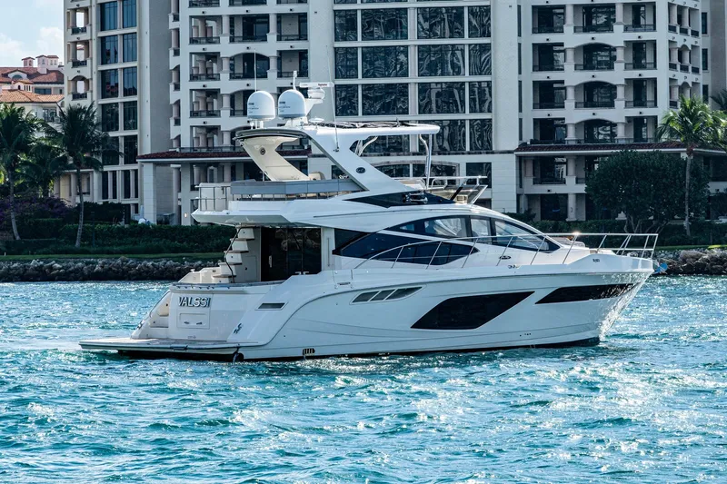  Yacht Photos Pics 2018 Sea Ray L550 Fly yacht cruising near luxury waterfront buildings.
