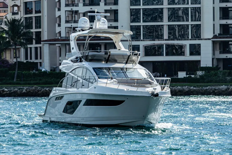  Yacht Photos Pics 2018 Sea Ray L550 Fly yacht cruising near waterfront buildings.