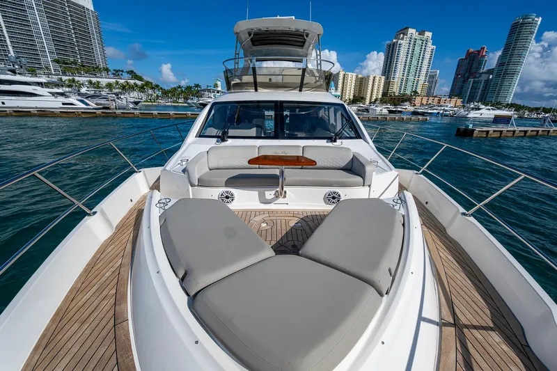  Yacht Photos Pics 2018 Sea Ray L550 Fly yacht with luxurious deck, docked in a vibrant marina.