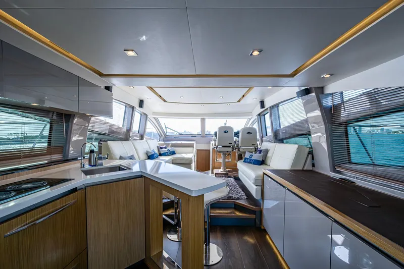  Yacht Photos Pics Luxurious interior of 2018 Sea Ray L550 Fly yacht with modern kitchen and seating area.
