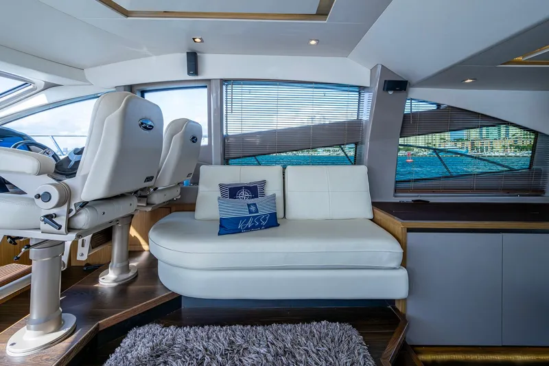 Yacht Photos Pics Luxurious interior of 2018 Sea Ray L550 Fly yacht with plush seating and scenic window views.