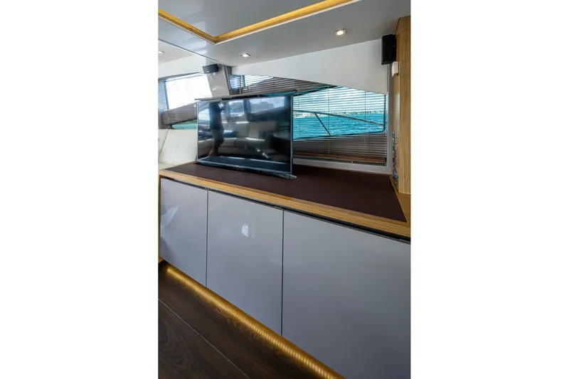 Yacht Photos Pics Luxurious interior of 2018 Sea Ray L550 Fly yacht with modern TV and sleek cabinetry.