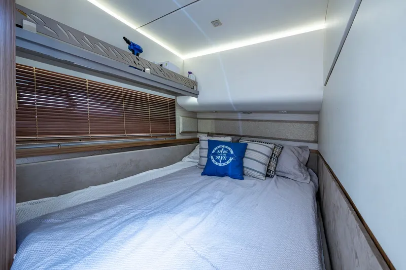  Yacht Photos Pics Luxurious bedroom interior of 2018 Sea Ray L550 Fly yacht with cozy bedding and nautical decor.