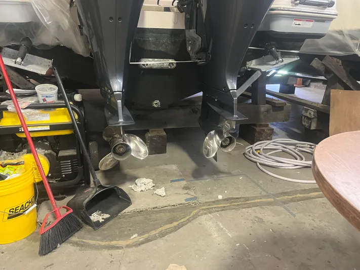  Yacht Photos Pics 2021 Robalo R272 Center Console boat engines in a workshop setting.