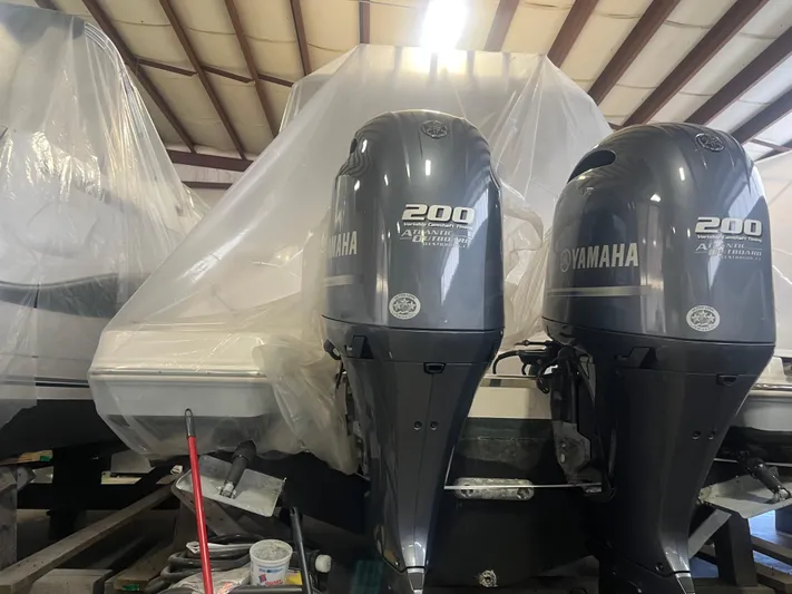  Yacht Photos Pics 2021 Robalo R272 Center Console with twin Yamaha 200 engines in storage.