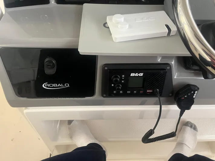  Yacht Photos Pics 2021 Robalo R272 Center Console dashboard with B&G marine radio and steering wheel.