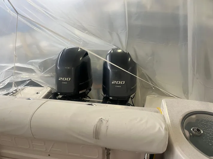  Yacht Photos Pics 2021 Robalo R272 Center Console with twin 200 HP engines under cover.