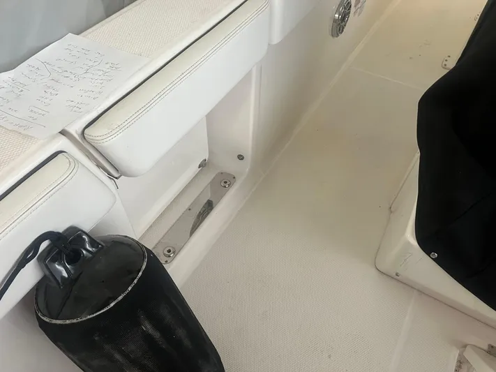  Yacht Photos Pics 2021 Robalo R272 Center Console interior with white seating and black fender.