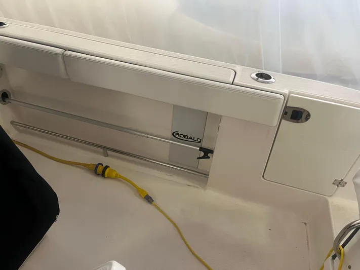  Yacht Photos Pics 2021 Robalo R272 Center Console boat interior with storage compartment and yellow cable.