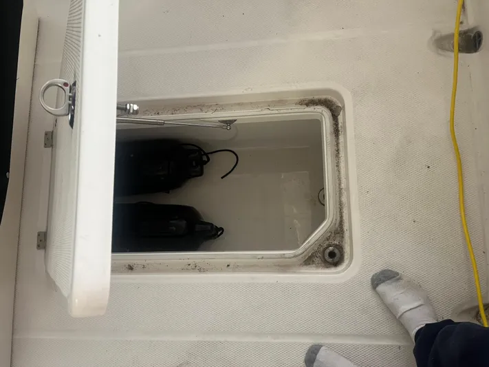  Yacht Photos Pics 2021 Robalo R272 Center Console storage compartment with open hatch and visible equipment.