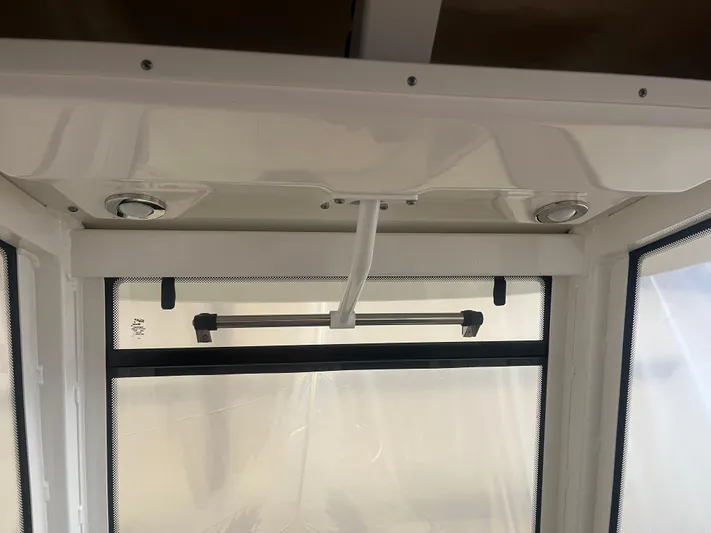  Yacht Photos Pics Interior view of 2021 Robalo R272 Center Console boat with window and ceiling details.