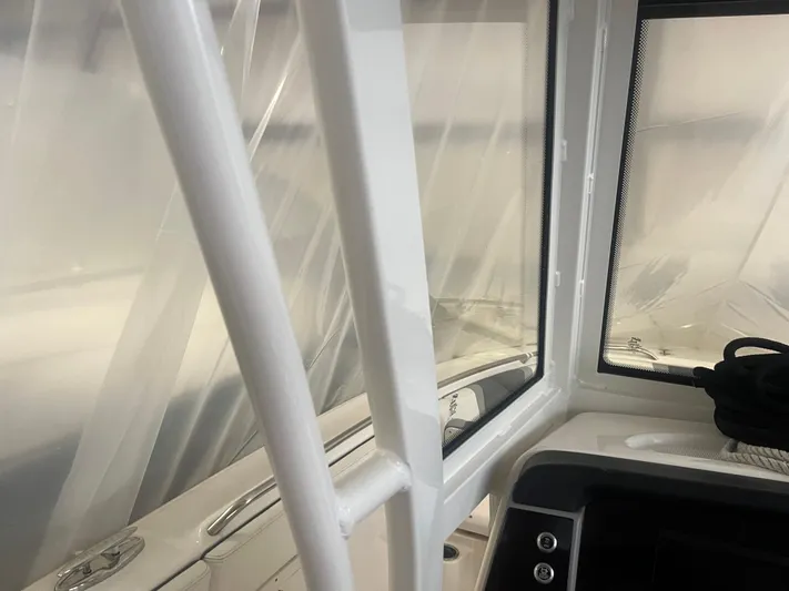  Yacht Photos Pics 2021 Robalo R272 Center Console interior with window and railing detail.