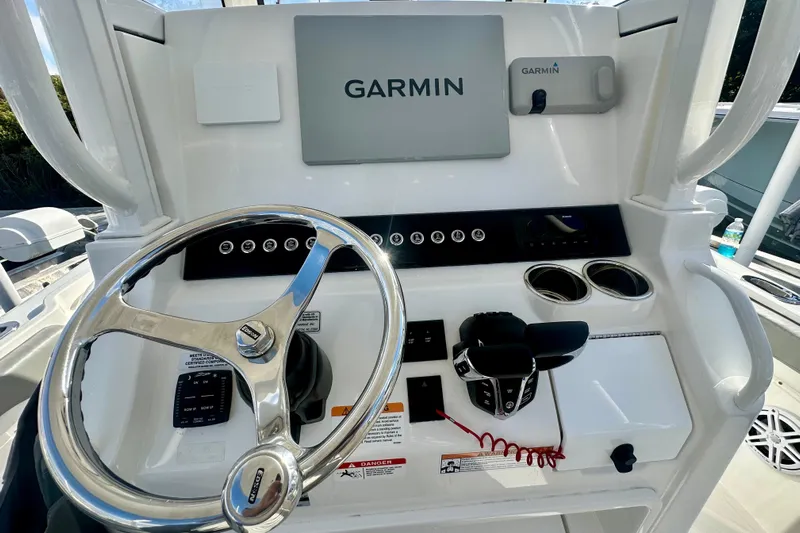  Yacht Photos Pics 2025 Regulator 23 boat dashboard with Garmin navigation system and steering wheel.