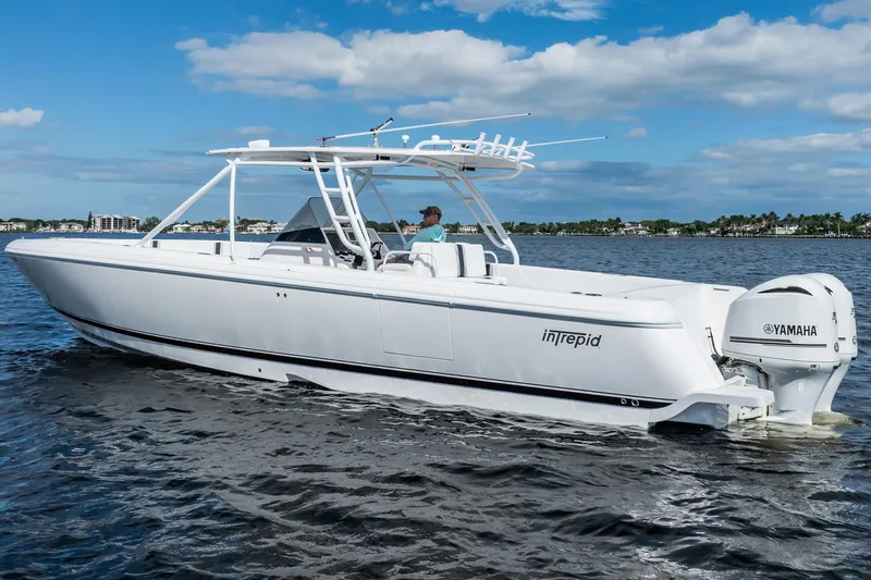  Yacht Photos Pics 2011 Intrepid 400 Center Console boat cruising on water under blue sky.