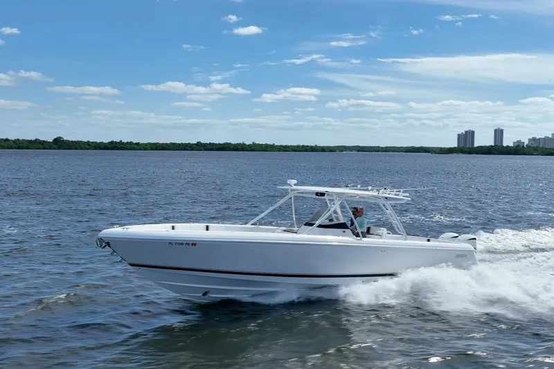  Yacht Photos Pics 2011 Intrepid 400 Center Console boat cruising on a sunny day, with city skyline in background.
