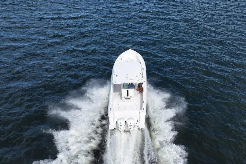  Yacht Photos Pics 2011 Intrepid 400 Center Console boat cruising on open water, aerial view.