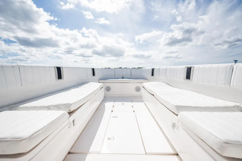  Yacht Photos Pics 2011 Intrepid 400 Center Console boat interior with white cushioned seating under a cloudy sky.