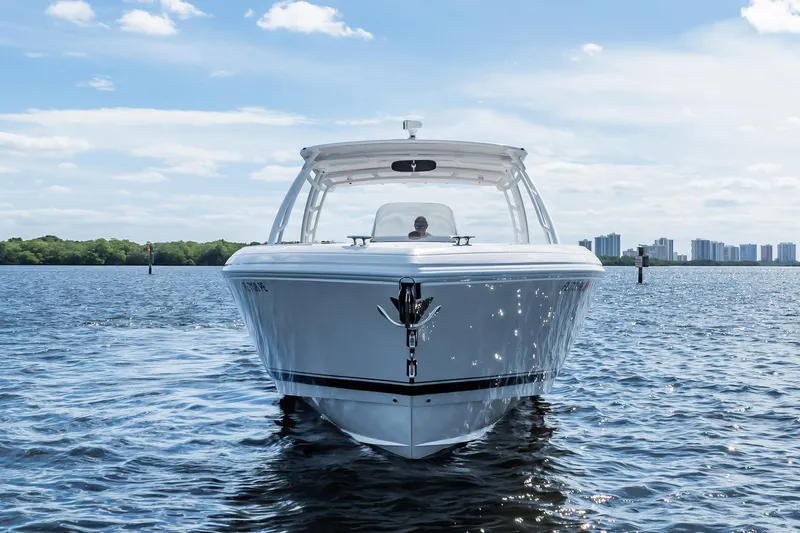  Yacht Photos Pics 2011 Intrepid 400 Center Console boat on calm water, city skyline in background.