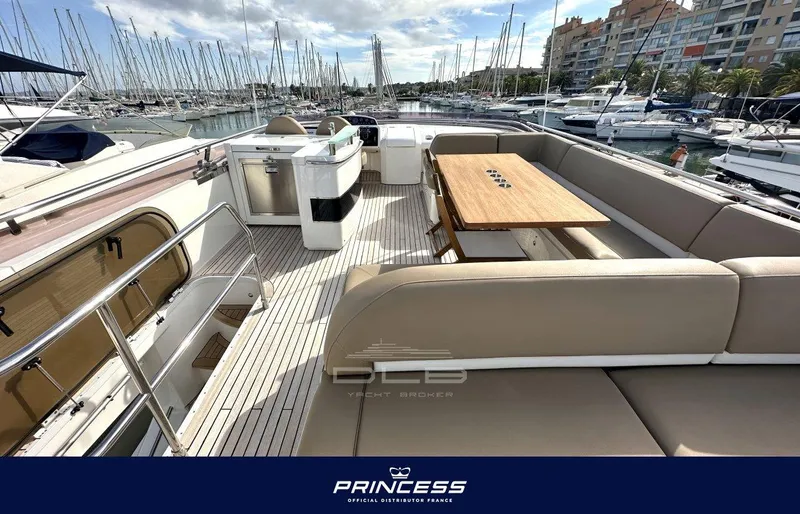  Yacht Photos Pics Luxurious 2012 Princess 64 yacht with spacious deck and elegant seating in a marina.