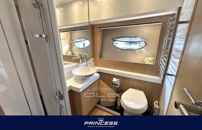  Yacht Photos Pics Luxurious bathroom in 2012 Princess 64 yacht with modern fixtures and porthole window.