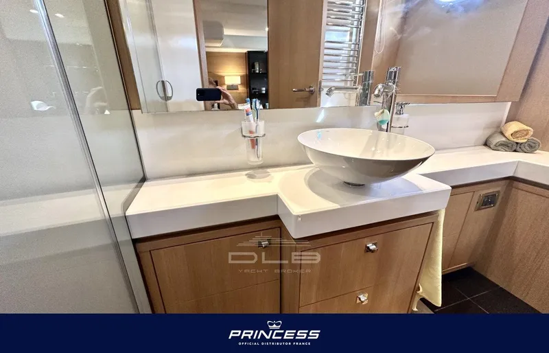  Yacht Photos Pics Luxurious bathroom in 2012 Princess 64 yacht with modern sink and elegant fixtures.