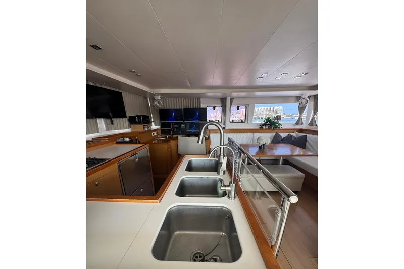 Audacity Yacht Photos Pics Interior of 2013 Lagoon 450 yacht with modern kitchen and dining area.