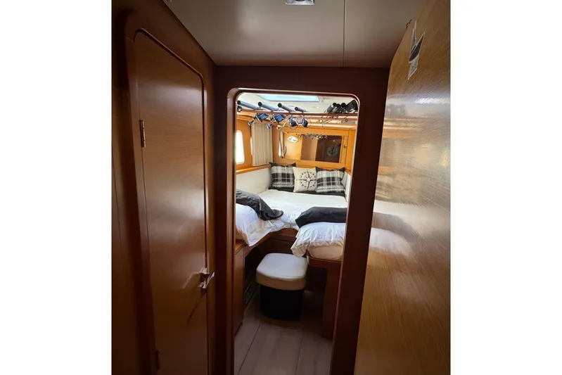 Audacity Yacht Photos Pics Cozy cabin interior of 2013 Lagoon 450 yacht with plush bedding and wooden finishes.