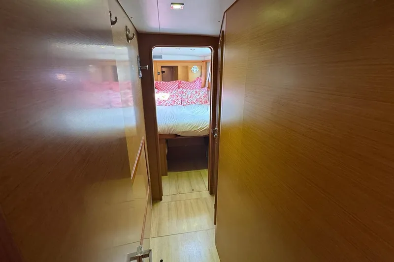 Audacity Yacht Photos Pics Interior hallway of 2013 Lagoon 450 yacht, leading to a cozy bedroom.