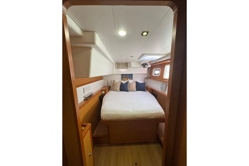 Audacity Yacht Photos Pics Cozy cabin interior of 2013 Lagoon 450 yacht with comfortable bedding and wooden accents.