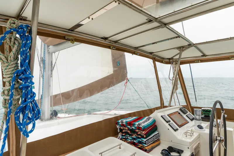 Audacity Yacht Photos Pics Interior view of 2013 Lagoon 450 catamaran cockpit with navigation equipment and colorful towels.