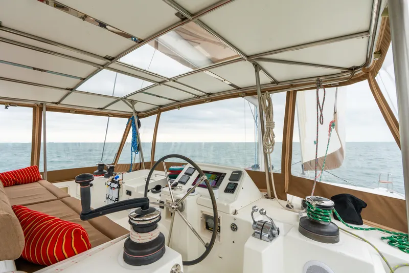Audacity Yacht Photos Pics Interior view of 2013 Lagoon 450 catamaran cockpit with ocean backdrop.