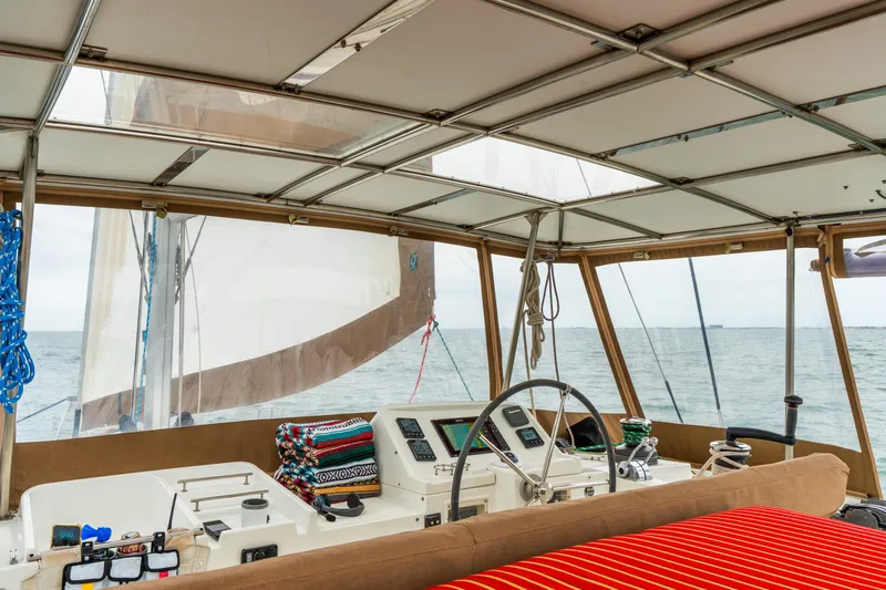 Audacity Yacht Photos Pics Interior view of 2013 Lagoon 450 catamaran cockpit with steering wheel and navigation instruments.