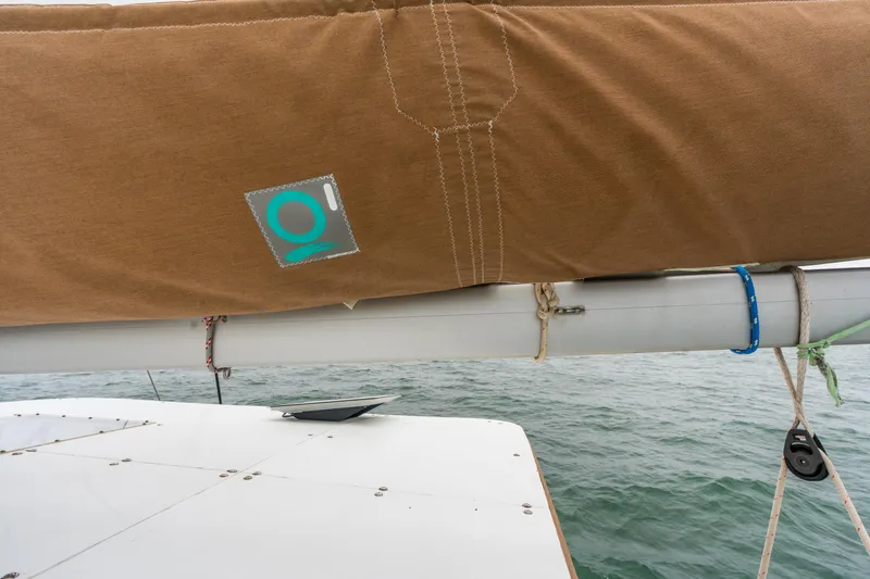 Audacity Yacht Photos Pics Sailboat boom with brown cover on 2013 Lagoon 450 catamaran, ocean background.