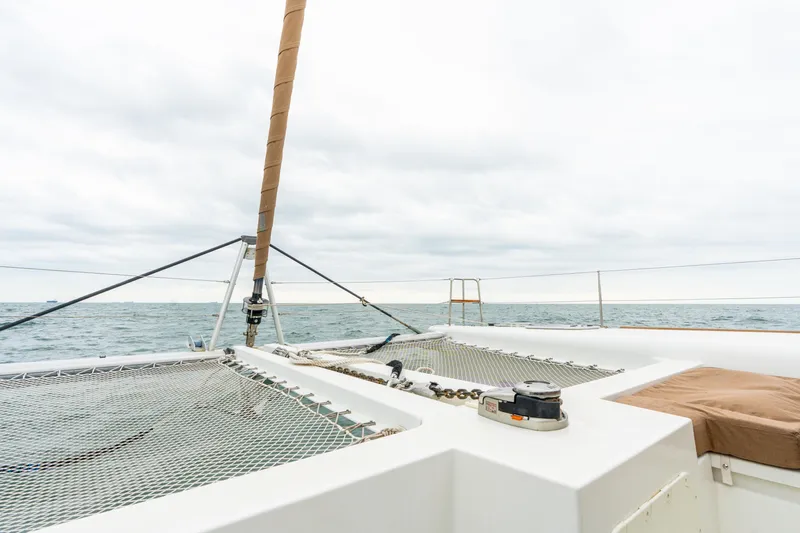 Audacity Yacht Photos Pics Lagoon 450 catamaran deck view, 2013 model, sailing on open sea under cloudy sky.