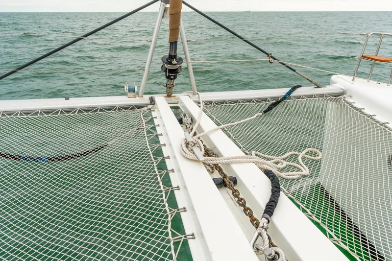 Audacity Yacht Photos Pics Catamaran deck with netting, Lagoon 450, 2013 model, sailing on open sea.
