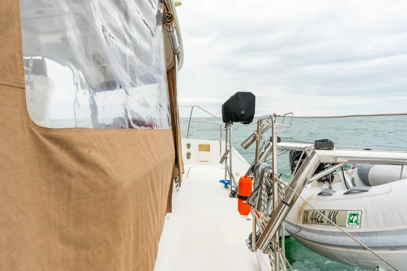 Audacity Yacht Photos Pics 2013 Lagoon 450 catamaran deck with dinghy and ocean view.