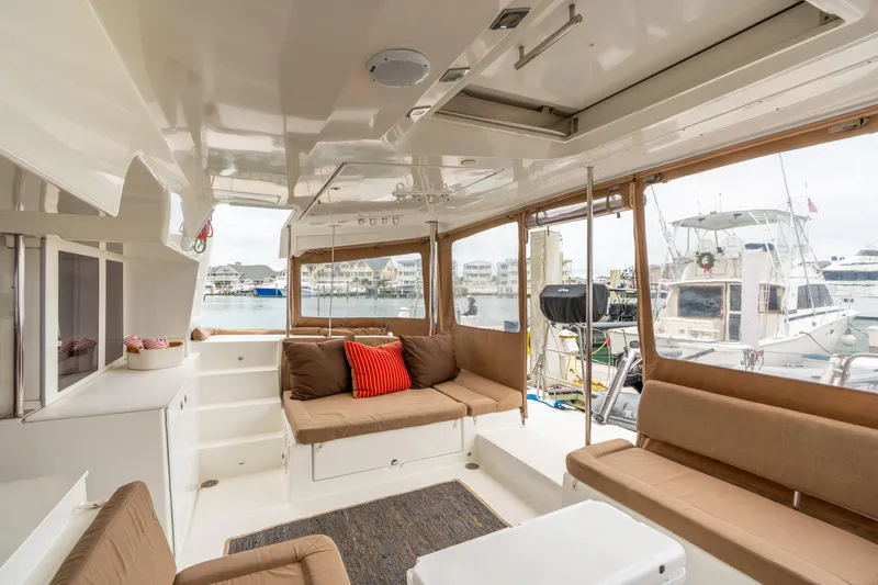 Audacity Yacht Photos Pics Interior of 2013 Lagoon 450 yacht with comfortable seating and marina view.