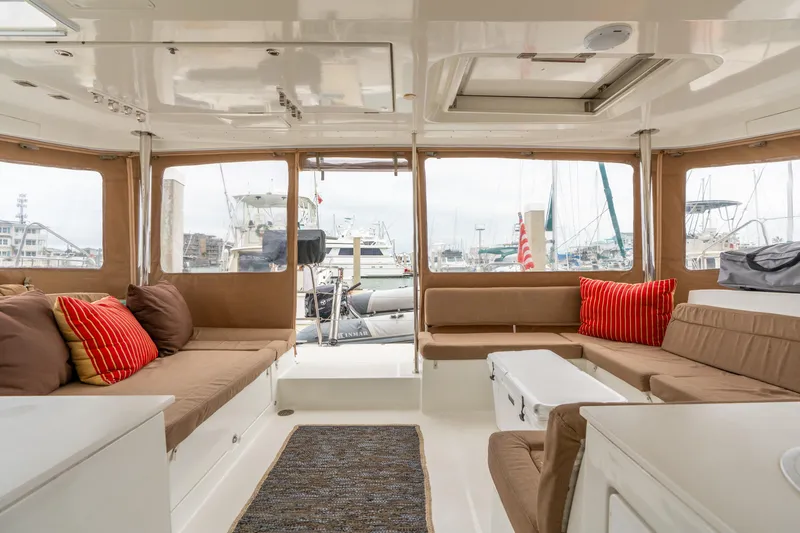 Audacity Yacht Photos Pics Interior of 2013 Lagoon 450 catamaran with cozy seating and marina view.