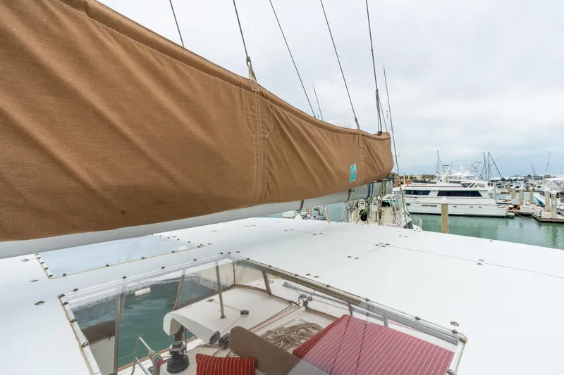 Audacity Yacht Photos Pics 2013 Lagoon 450 catamaran docked at marina, featuring covered sail and spacious deck.