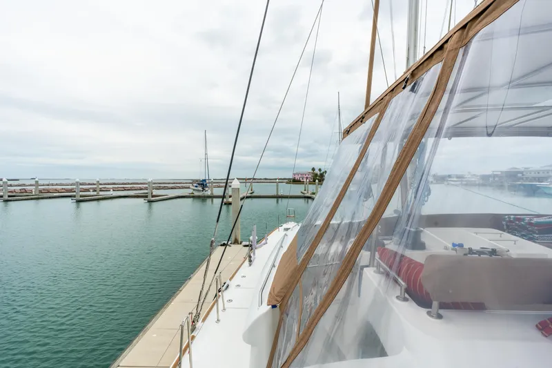 Audacity Yacht Photos Pics Lagoon 450 catamaran docked at marina, showcasing deck and clear canopy, 2013 model.