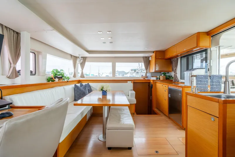 Audacity Yacht Photos Pics Luxurious interior of 2013 Lagoon 450 yacht with modern kitchen and dining area.