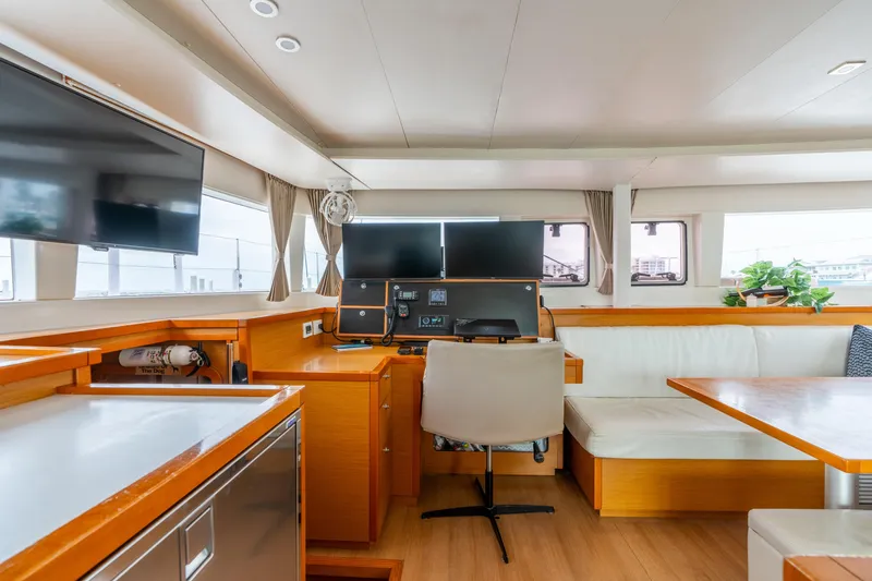 Audacity Yacht Photos Pics Interior of 2013 Lagoon 450 yacht with modern navigation station and seating area.