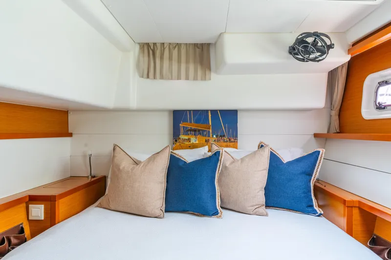 Audacity Yacht Photos Pics Cozy cabin interior of 2013 Lagoon 450 yacht with stylish pillows and nautical decor.