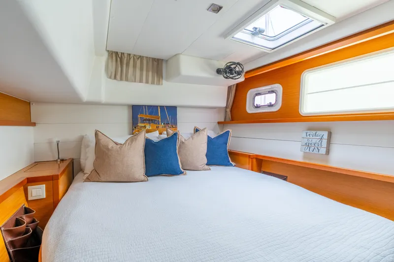 Audacity Yacht Photos Pics Luxurious cabin interior of 2013 Lagoon 450 catamaran with cozy bedding and natural light.