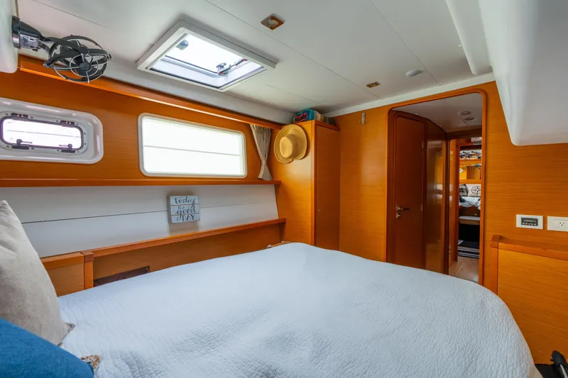 Audacity Yacht Photos Pics Cozy cabin interior of 2013 Lagoon 450 catamaran with wood finish and natural light.