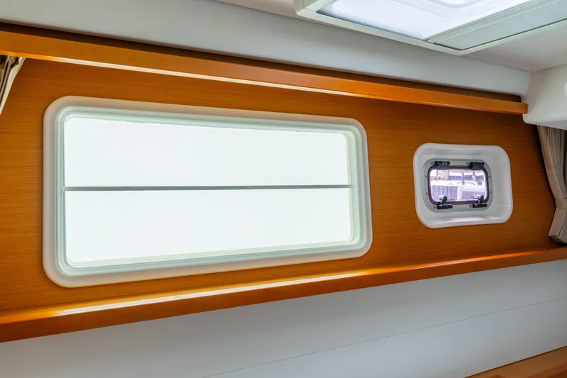 Audacity Yacht Photos Pics Interior view of Lagoon 450 yacht, 2013 model, featuring sleek wooden paneling and windows.