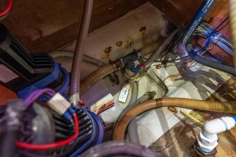 Audacity Yacht Photos Pics Bilge area of a 2013 Lagoon 450 catamaran with visible hoses and wiring.