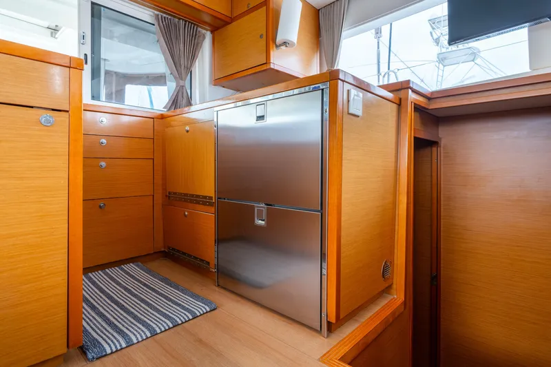Audacity Yacht Photos Pics Interior of 2013 Lagoon 450 yacht with wooden cabinetry and stainless steel appliances.