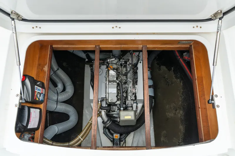 Audacity Yacht Photos Pics Engine compartment of a 2013 Lagoon 450 catamaran, showcasing mechanical components and storage.
