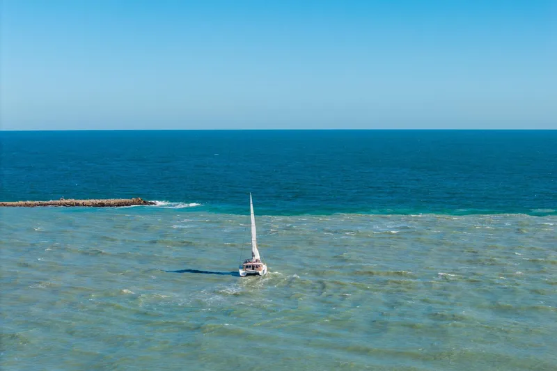 Audacity Yacht Photos Pics Sailboat Lagoon 450 (2013) navigating calm blue ocean waters.